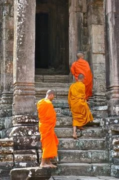 Three monks walking into the temple. Stock Photos
