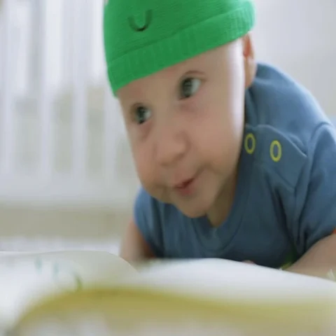 The three-month child is looking to the camera lying on the floor. Stock Footage 69301168