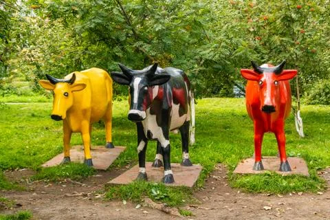Three monuments multicolored cows black and white and red and yellow Stock Photos