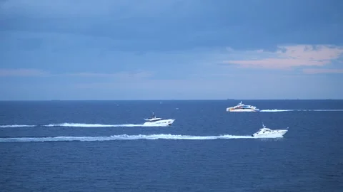 Three motorboats speeding across the open ocean water, Stock Footage 328612187