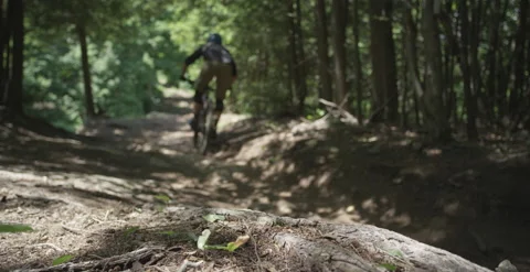 Three mountain bikers racing down the hill on downhill mountain bikes Stock Footage 157326554
