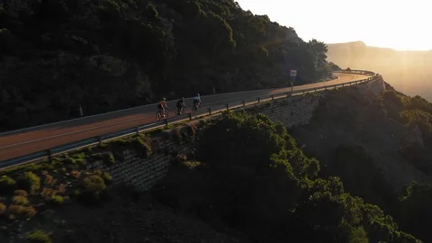 Three mountain bikers riding on the mountain road Stock-Footage 102189924