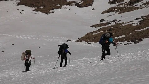 Three mountaineers with backpacks (elbrus) Stock Footage 83731137