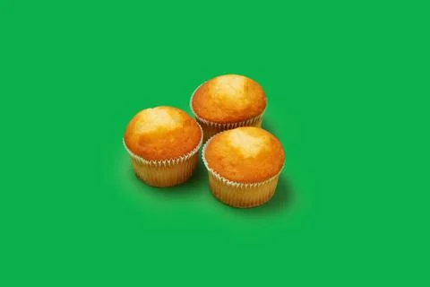 Three muffins on a colored background Stock Photos