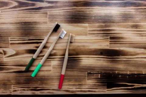 Three multi-colored bamboo toothbrushes. eco friendly. Stock-Fotos