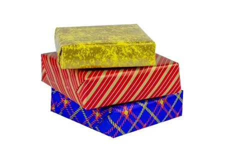 Three multi-colored boxes with gifts on a white background. Stock Photos
