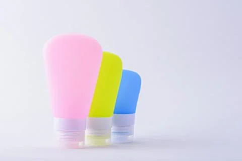 Three multi-colored cosmetic tubes on white background Stock Photos