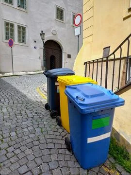Three multi-colored garbage bins for collecting different types of garbage Stock Photos