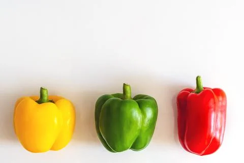 Three multi-colored paprikas on a white background copyspace Stock Photos