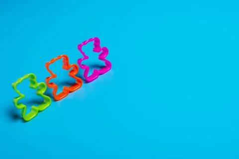 Three multi-colored plastic cookie cutter for making cookies in the shape of  Foto stock