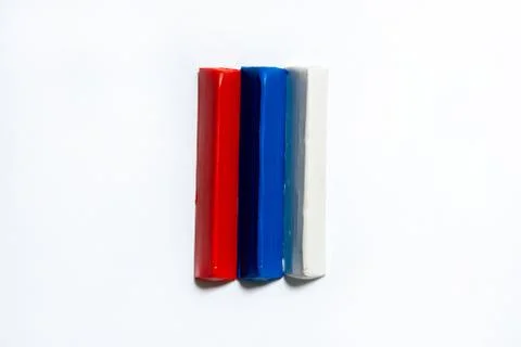 Three multi-colored plasticine bars on a white background. Stock Photos