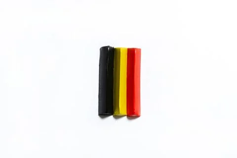 Three multi-colored plasticine bars on a white background Foto stock