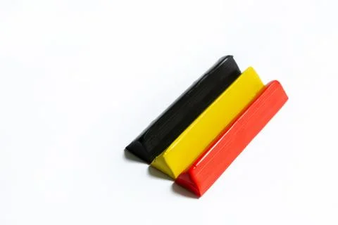 Three multi-colored plasticine bars on a white background. Stock Photos