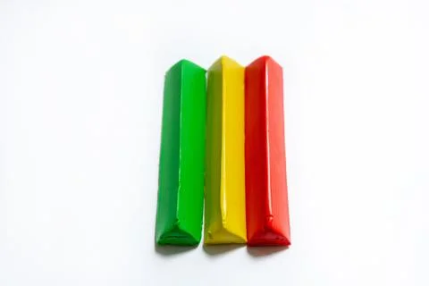 Three multi-colored plasticine bars on a white background. Stock Photos