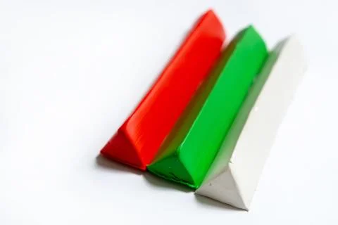Three multi-colored plasticine bars on a white background. Stock Photos