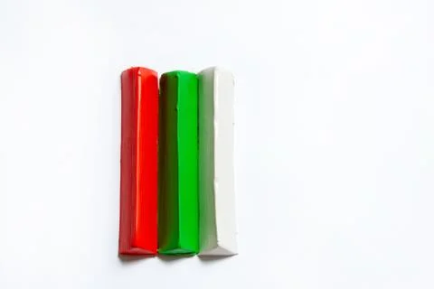 Three multi-colored plasticine bars on a white background. Stock Photos