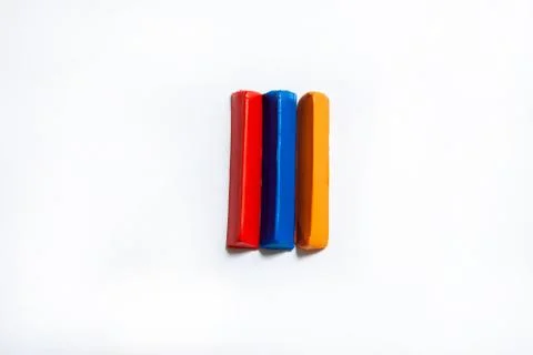 Three multi-colored plasticine bars on a white background. Foto stock