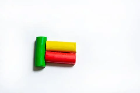 Three multi-colored plasticine bars on a white background. Stock Photos