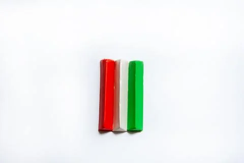 Three multi-colored plasticine bars on a white background. Stock Photos
