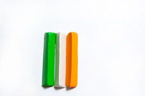 Three multi-colored plasticine bars on a white background. Stock Photos