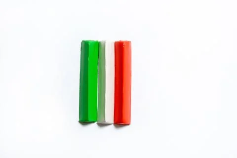 Three multi-colored plasticine bars on a white background. Stock Photos