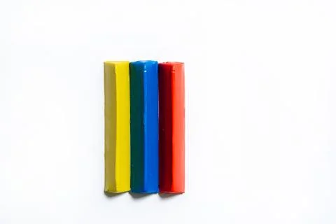 Three multi-colored plasticine bars on a white background Stock Photos