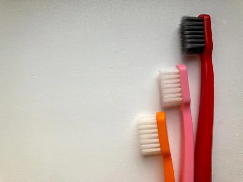 Three multi-colored toothbrushes on a white background 写真素材