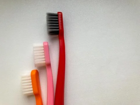 Three multi-colored toothbrushes on a white background Stock Photos