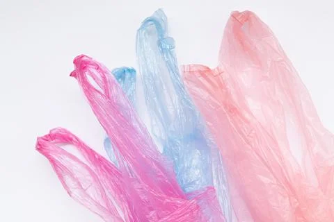 Three multi-colored transparent plastic bags with handles on a white backgrou Stock-Fotos