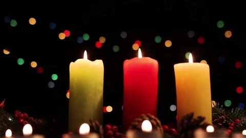 Three multi-colored вurning candles on a Christmas background Stock Footage 83416044