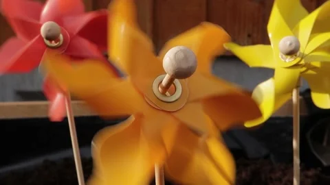 Three multi coloured pinwheel spinning in the wind. Sunny day Stock Footage 155919490
