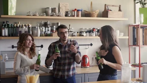 Three multi-race friends is having a perty with beer and sparkler in a home Stock Footage 73587340