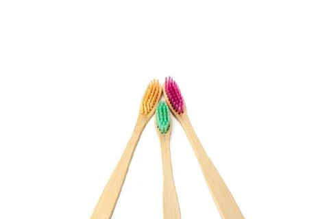 Three multicolored bamboo toothbrushes isolated on a white background. copy.. Stock Photos