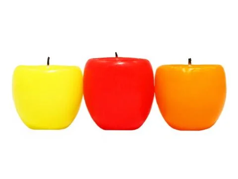 Three multicolored candles. Stock Photos