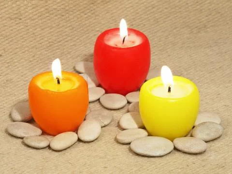 Three multicolored candles. Stock Photos