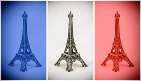Three multicolored Eiffel Tower models on french flag 스톡 사진