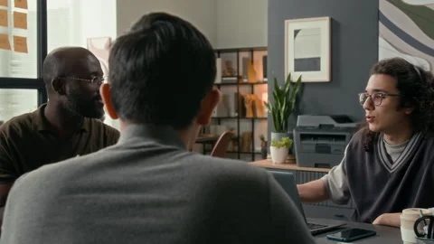 Three Multiethnic Young Web Engineers Having Group Discussion in Modern Office Stock Footage 329612688