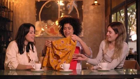 Three multiracial friends at coffee shop making anniversary gifts. Happy people Stock Footage 246831176