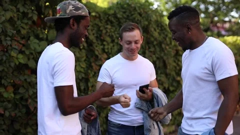 Three multiracial friends play a game and laugh Stock Footage 140842305