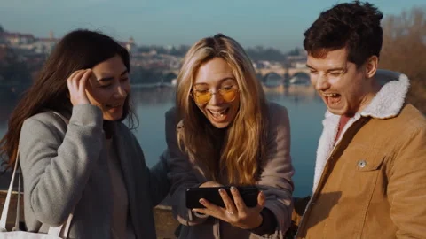 Three multirass friends are standing on the Charles Bridge in Prague and Stock Footage 219368745
