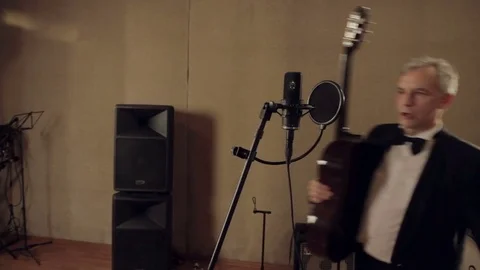 Three musicians sing in the recording studio. Stock Footage 80666682