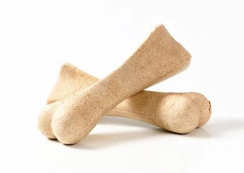 Three natural dog chew bones on plain background Stock Photos