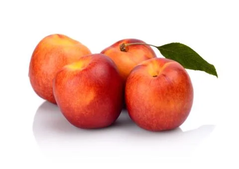 Three nectarines with leaf isolated on white background Foto stock