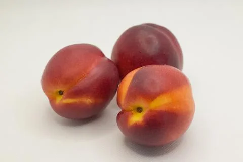 Three nectarines on a white background Stock Photos