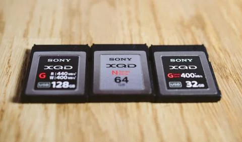 Three new XQD memory card by Sony  on wooden table Foto stock
