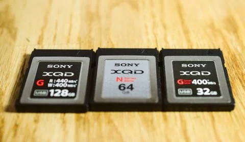 Three new XQD memory card by Sony  on wooden table Foto stock
