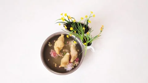 Three newborn ducklings bathe in a stainless steel basin with rose petals Stock Footage 315162807