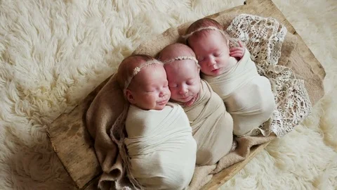 Three newborn triplets sisters Stock Footage 85399713