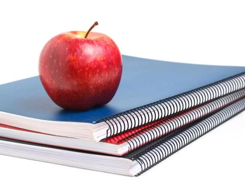 Three notebooks and red apple Stock Photos