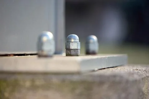 Three nuts are sitting on a gray surface Stock Photos